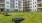 a grassy area with tables and benches in front of a building