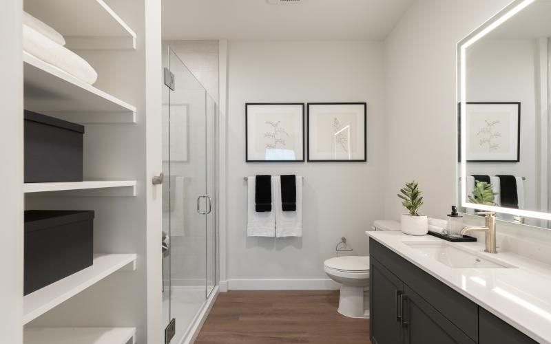 a bathroom with a sink toilet and mirror