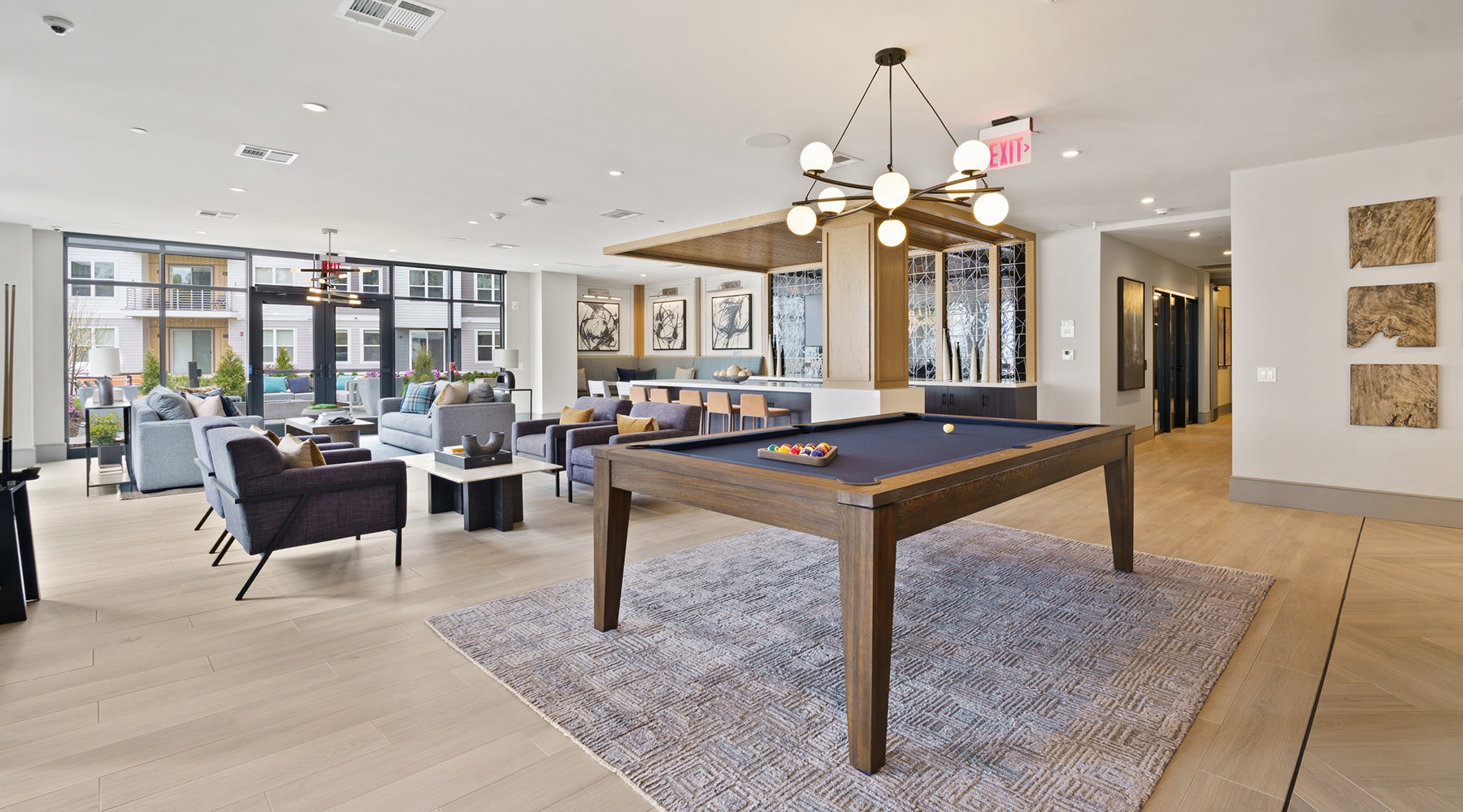 Surround Yourself with Style Large community clubroom with a table and chairs at Hathon